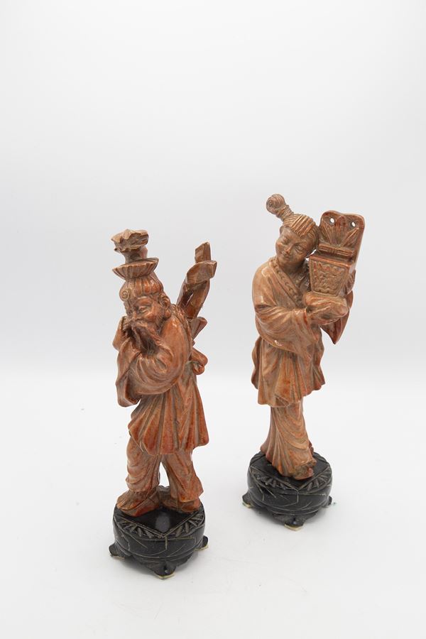 Pair of pink stone figurines depicting two oriental peasants.